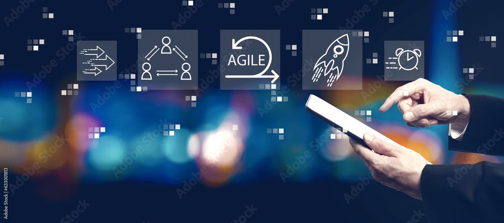 Agile concept with businessman using a tablet computer at night