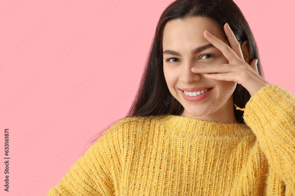 Beautiful young woman on pink background, closeup