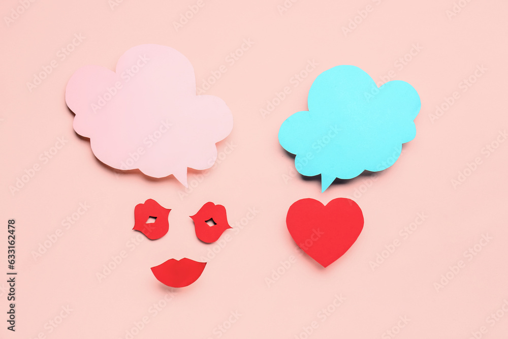 Paper lips and and heart with blank speech bubbles on pink background