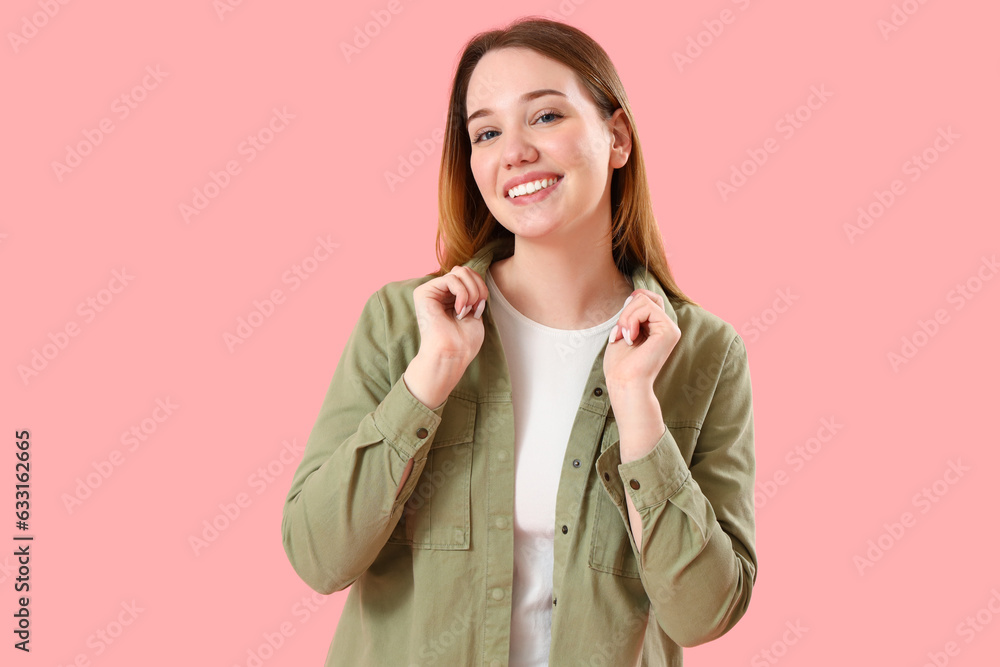 Beautiful young woman on pink background