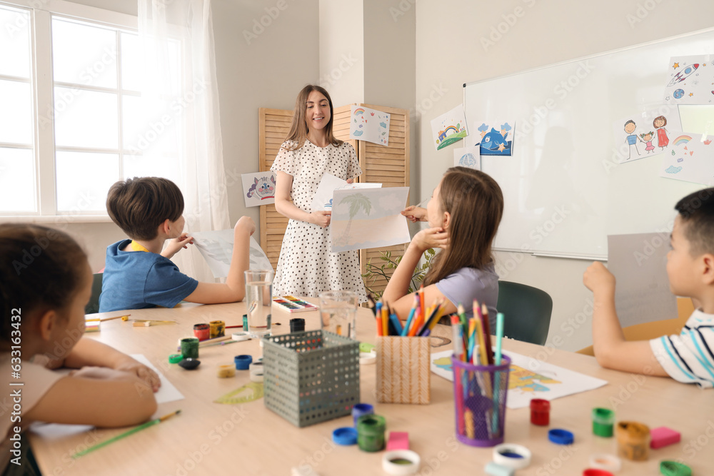 Little pupils with teacher in art class