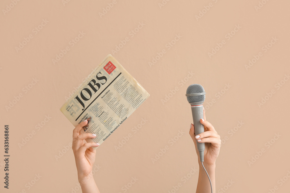 Female hands with microphone and newspaper on color background