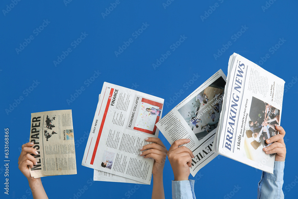 Female hands with different newspapers on blue background