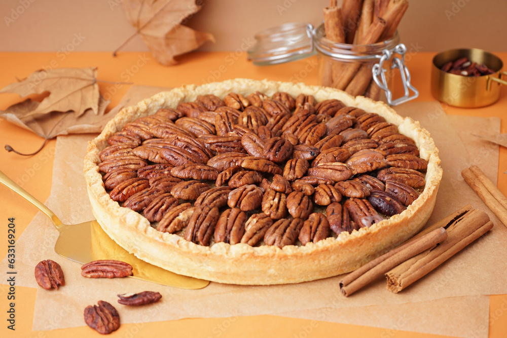 Tasty pecan pie on orange background