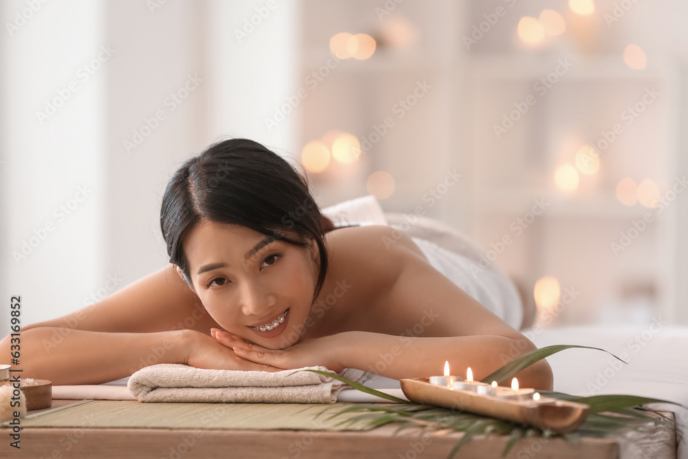 Pretty young Asian woman in spa salon