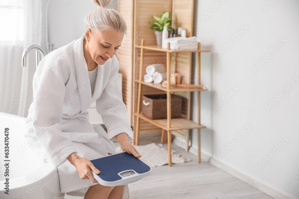 Mature woman with scales in bathroom