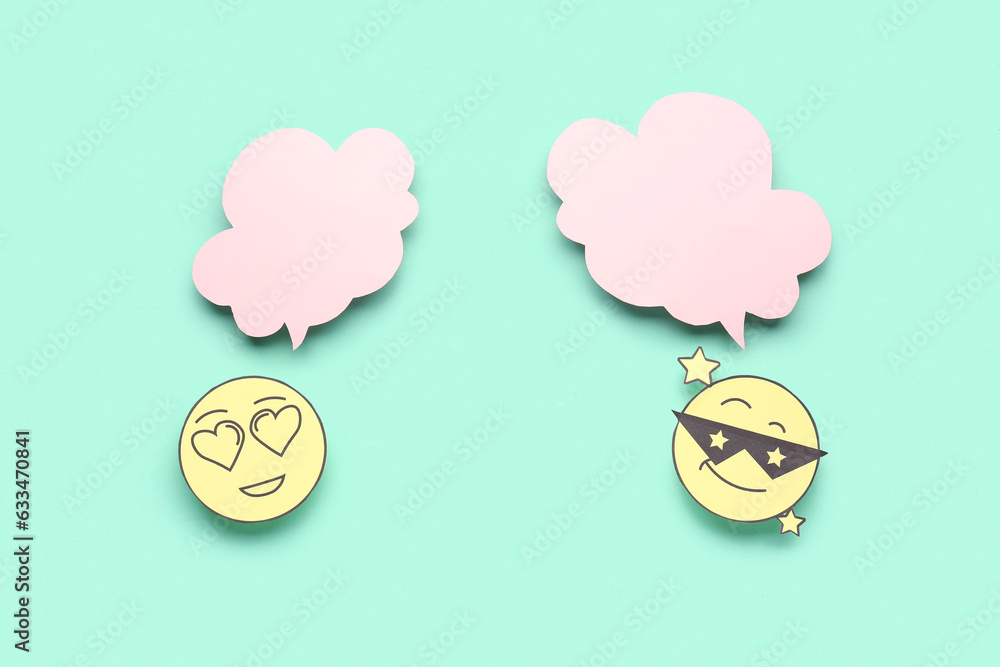 Paper faces with blank speech bubbles on turquoise background