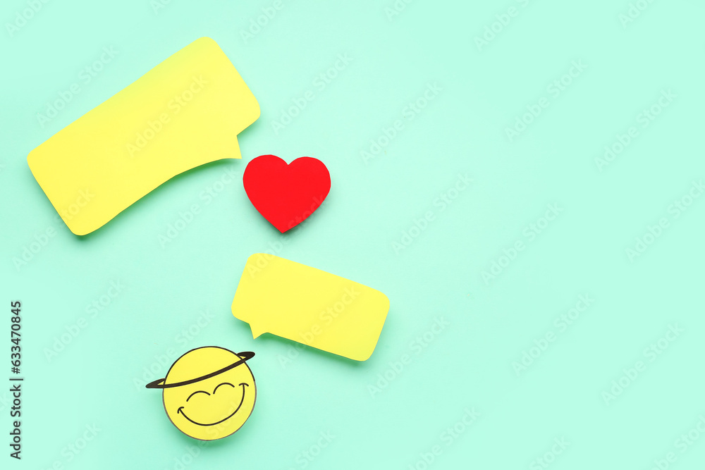 Happy face and heart with blank speech bubbles on turquoise background