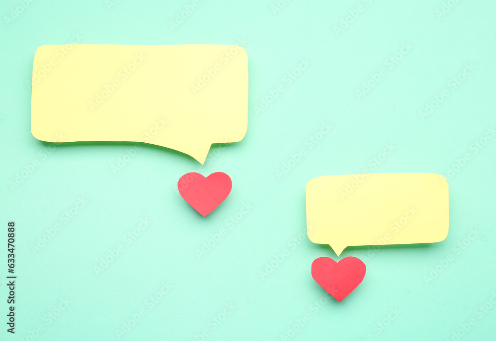 Paper hearts with blank speech bubbles on turquoise background