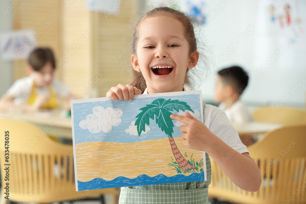 Cute little girl with drawing in art class