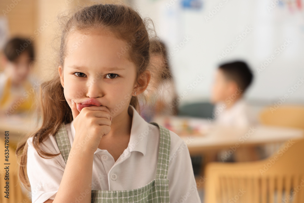 Thoughtful little girl in art class, closeup