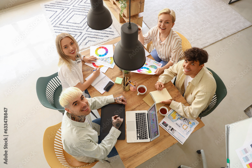 Team of graphic designers working at table in office