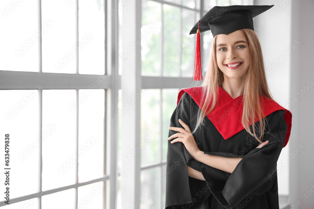 Female graduate student near window in room