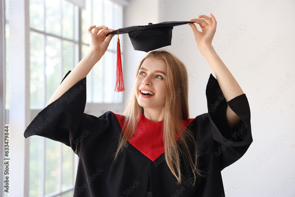 Female graduate student near window in room