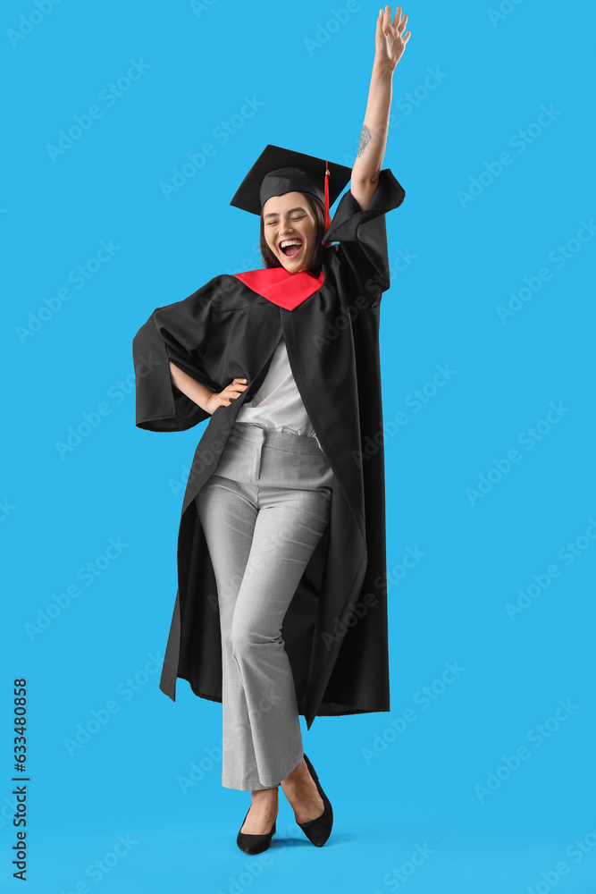 Happy female graduate student on blue background