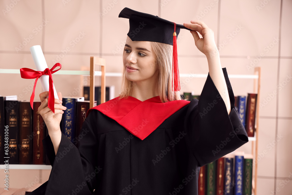 Female graduate student with diploma in library