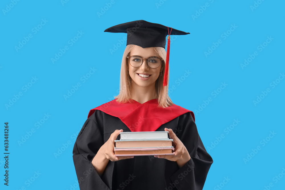 Female graduate student with books on blue background