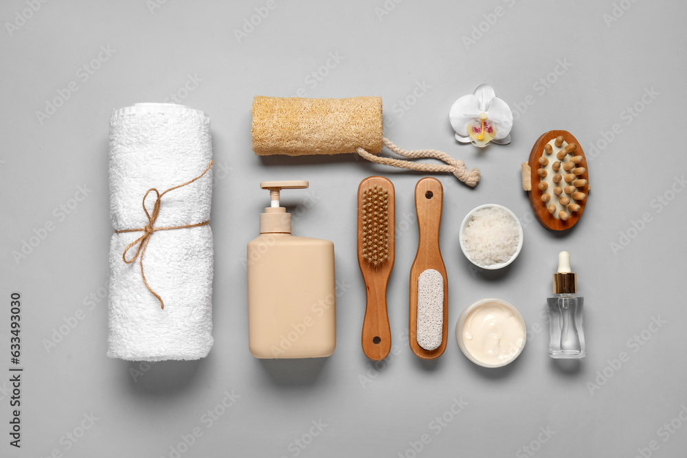 Composition with different bath supplies and cosmetic products on grey background