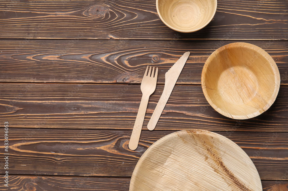 Different tableware on wooden background