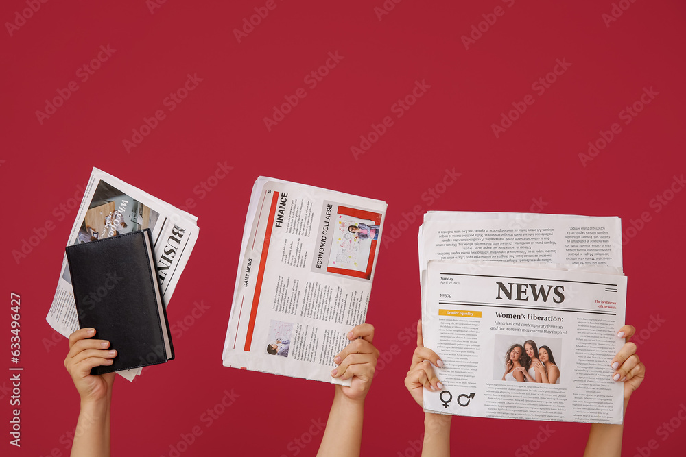 Female hands with newspapers and notebook on color background