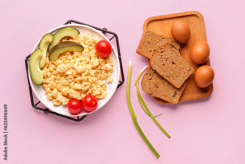 Plate of tasty scrambled eggs with avocado and tomatoes on pink background