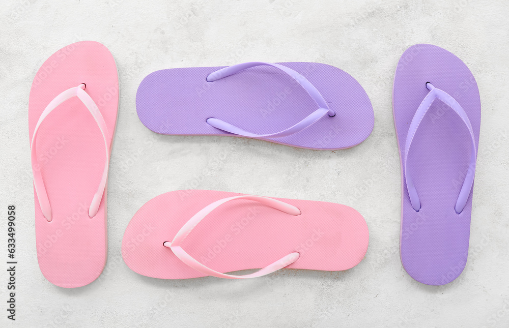 Colorful pairs of flip flops on white background