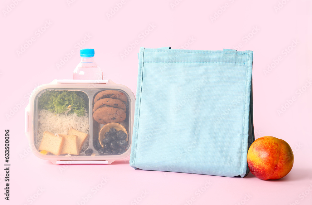 Bag, lunchbox with delicious food and bottle of water on pink background