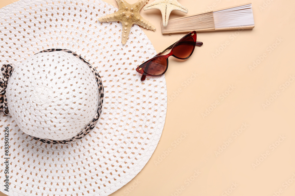 Stylish female hat, sunglasses, fan and starfishes on color background