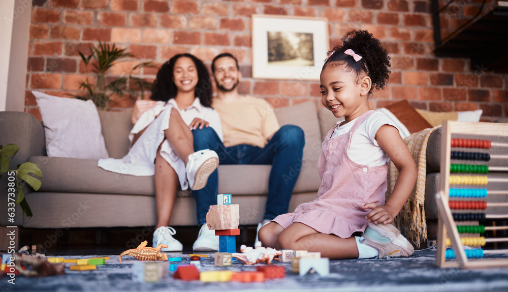 Happy, playing and a child with building blocks and parents for relax, education and learning in a h