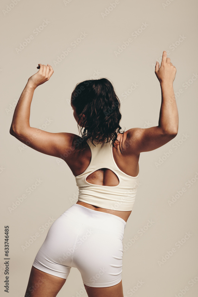 Young female athlete improving her strength and flexibility in a workout