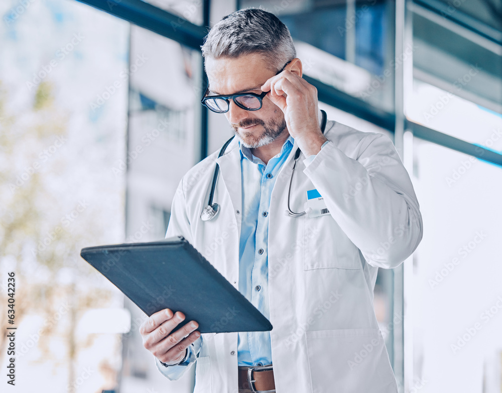 Mature doctor man, reading tablet and thinking with report, medical information or paperwork for ins