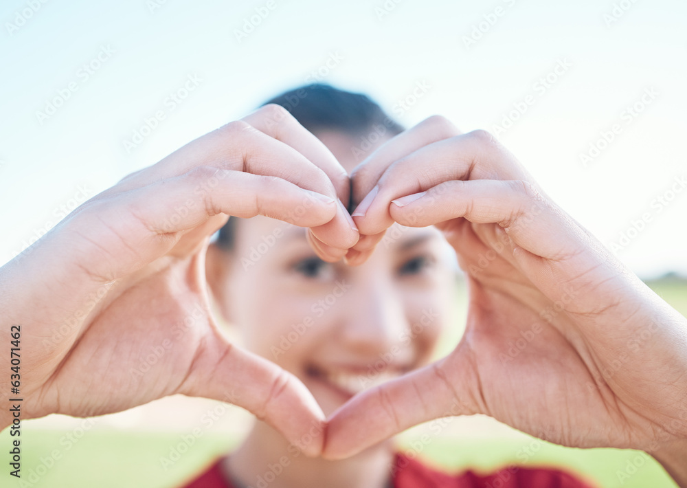 Heart shape, closeup and hands of woman with a care, sweet and cute gesture outdoor on a field. Happ