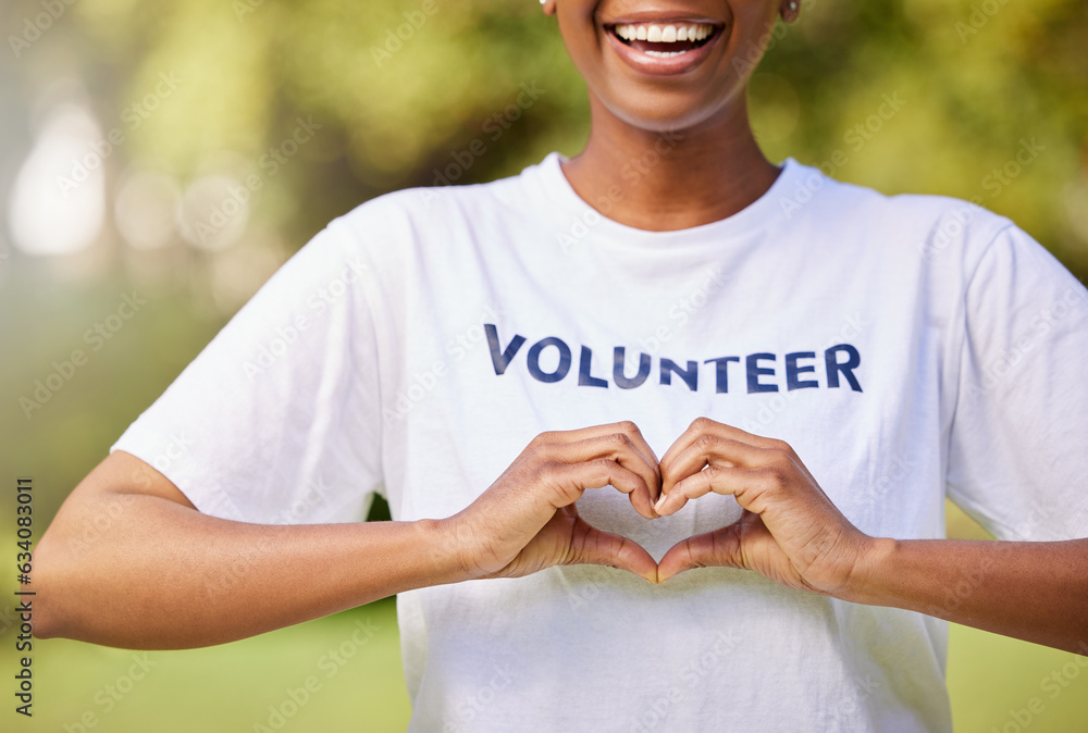 Heart, hands and volunteer smile with sign for care, support and charity outdoor in nature, forest o