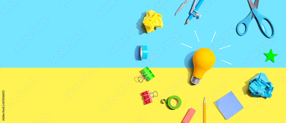 Idea light bulb with school supplies overhead view - flat lay