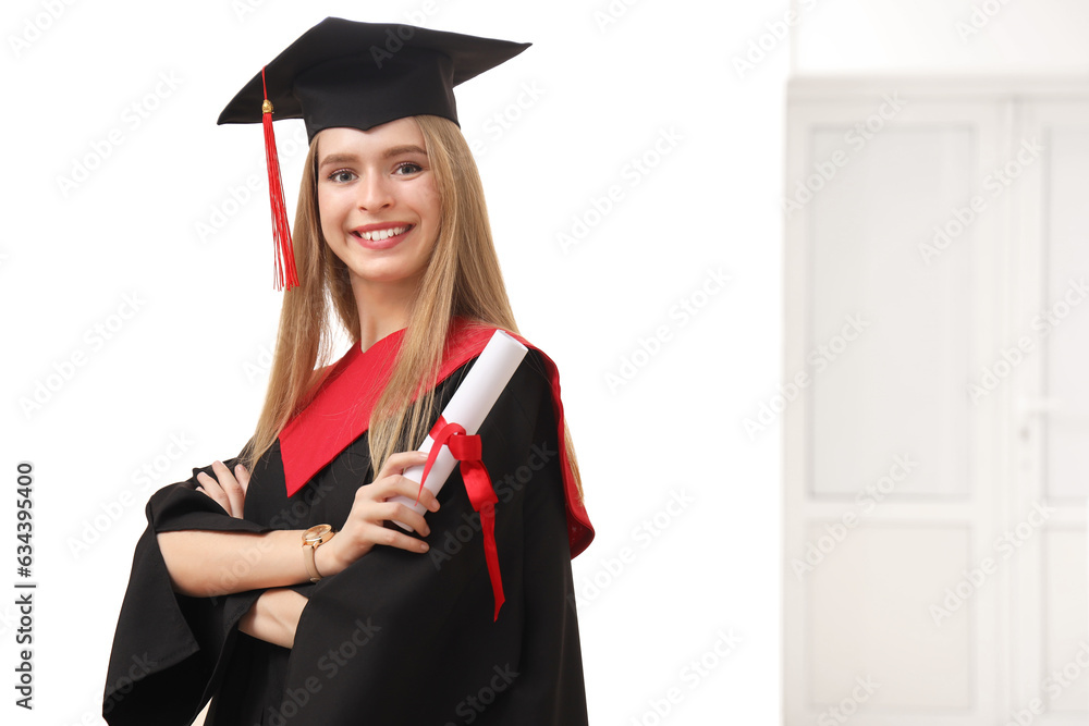 Female graduate student with diploma in hall