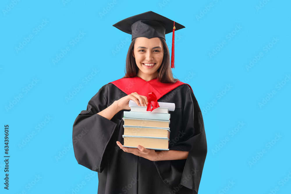 Female graduate student with diploma and books on blue background