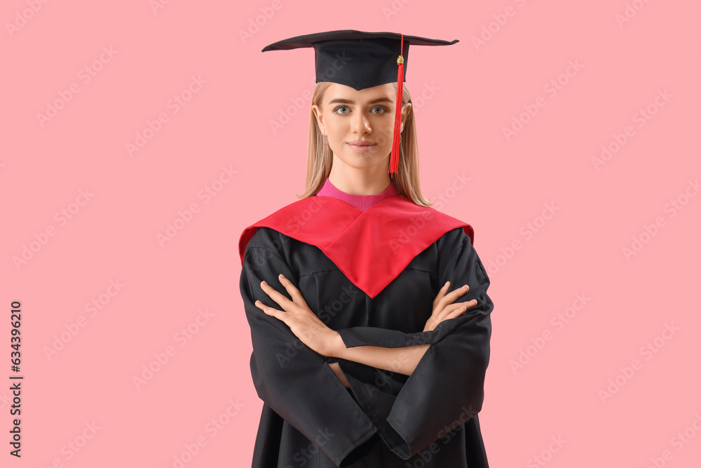 Female graduate student on pink background