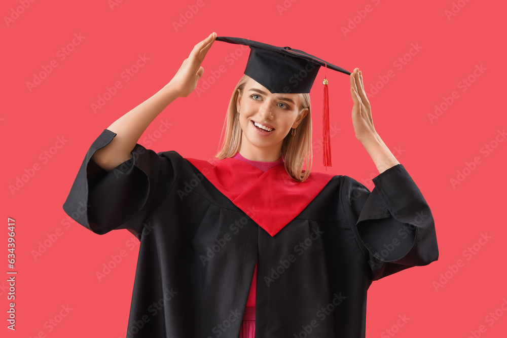 Female graduate student on red background