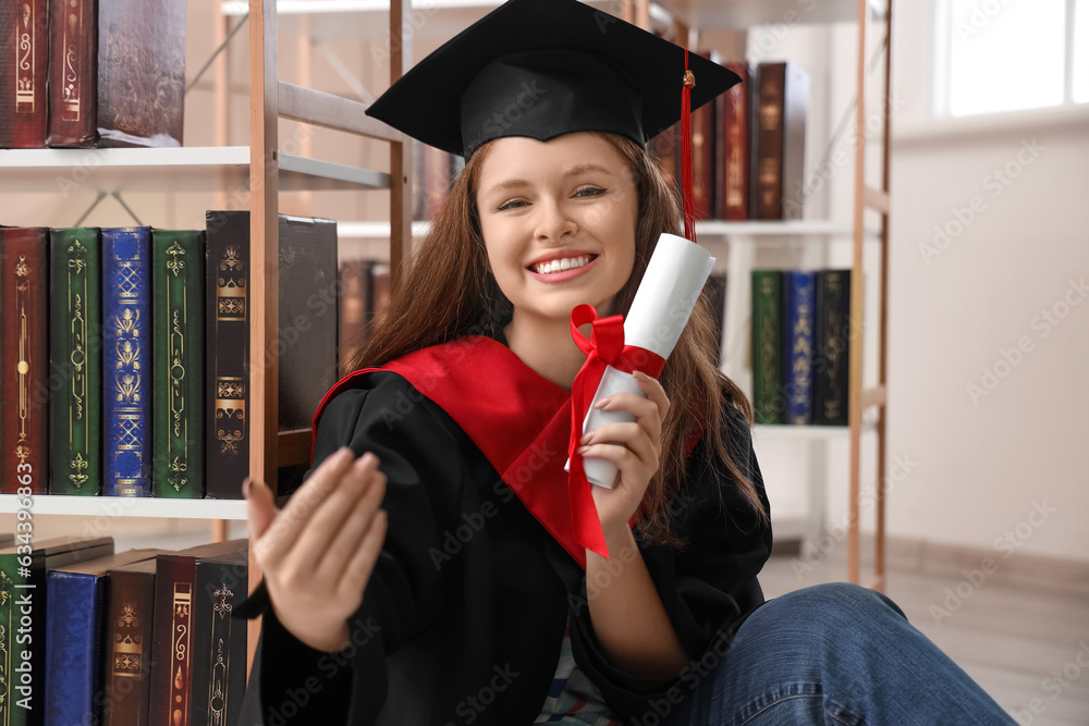 Female graduate student with diploma in library