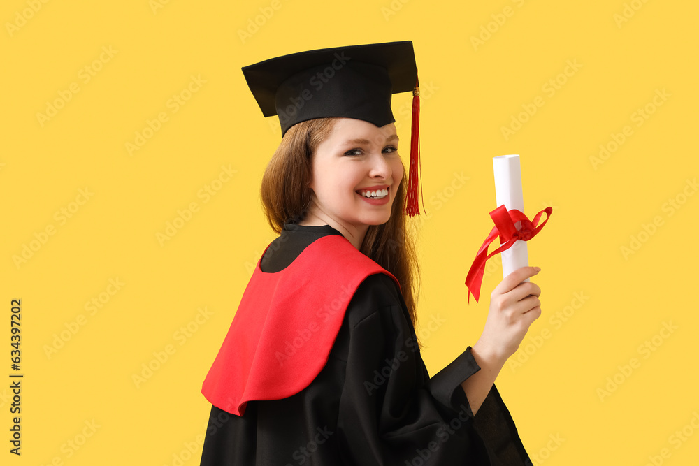 Female graduate student with diploma on yellow background