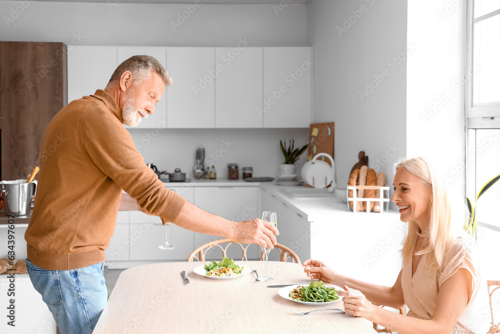 Mature couple having dinner in kitchen