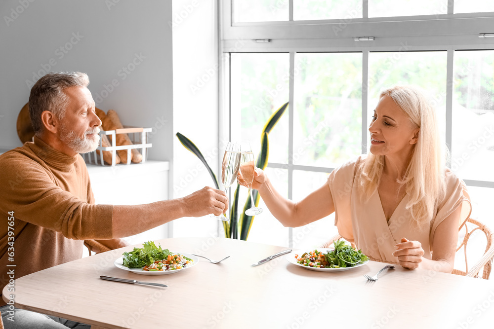 Mature couple having dinner in kitchen