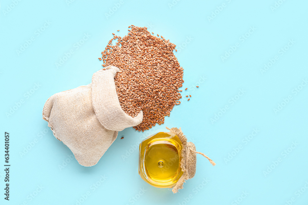 Jar of flax oil and sack bag with seeds on blue background