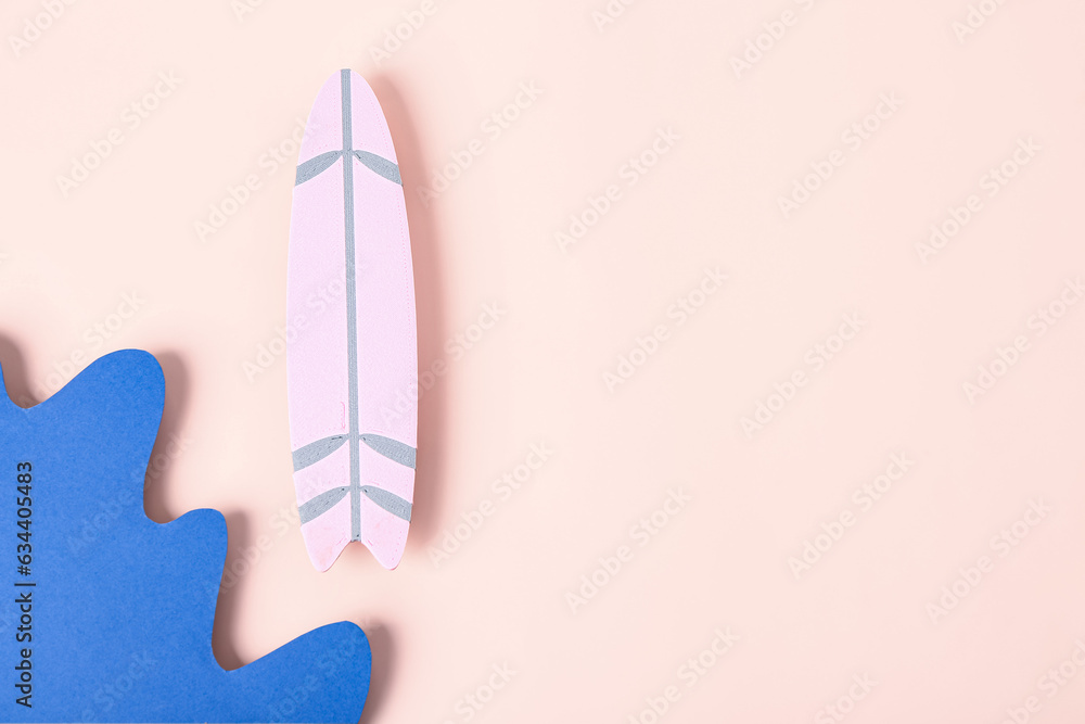 Creative composition with paper waves and mini surfboard on pink background