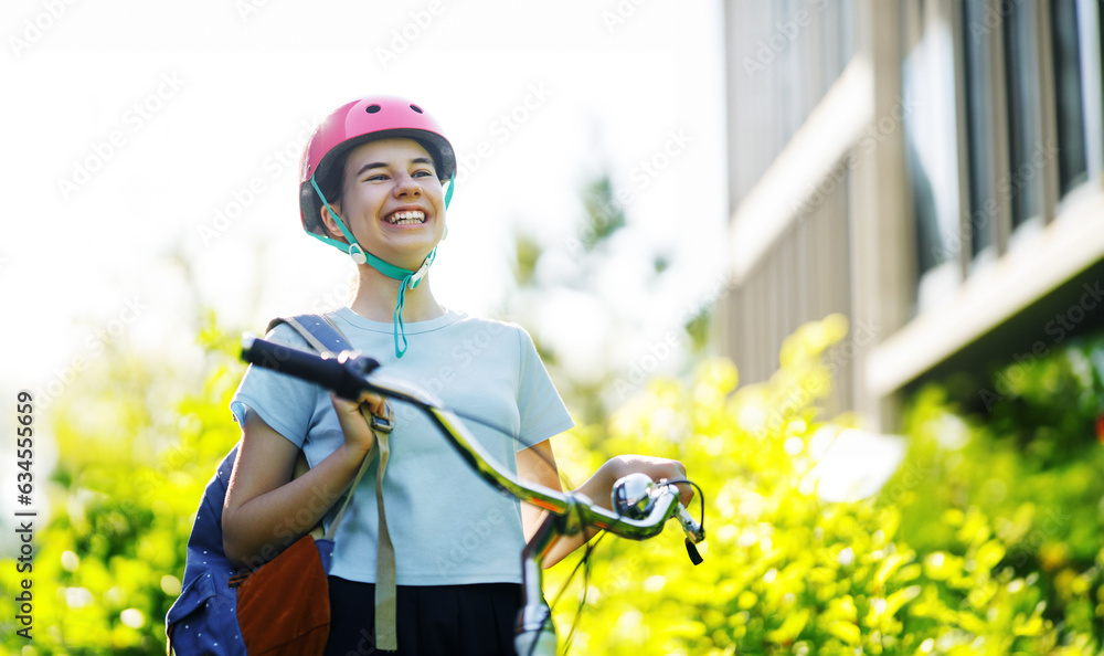 happy school girl riding a bicycle