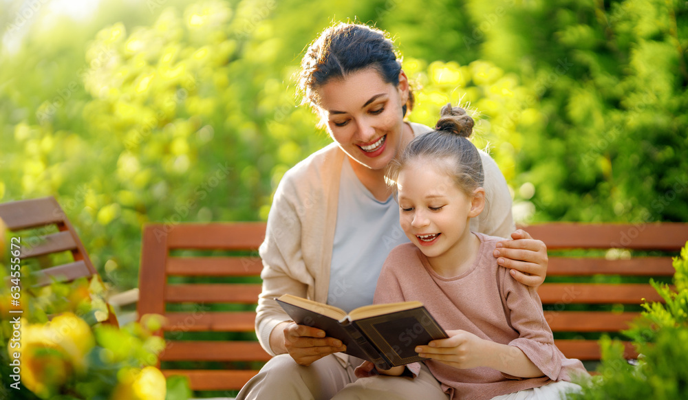 girl and her mother reading a book