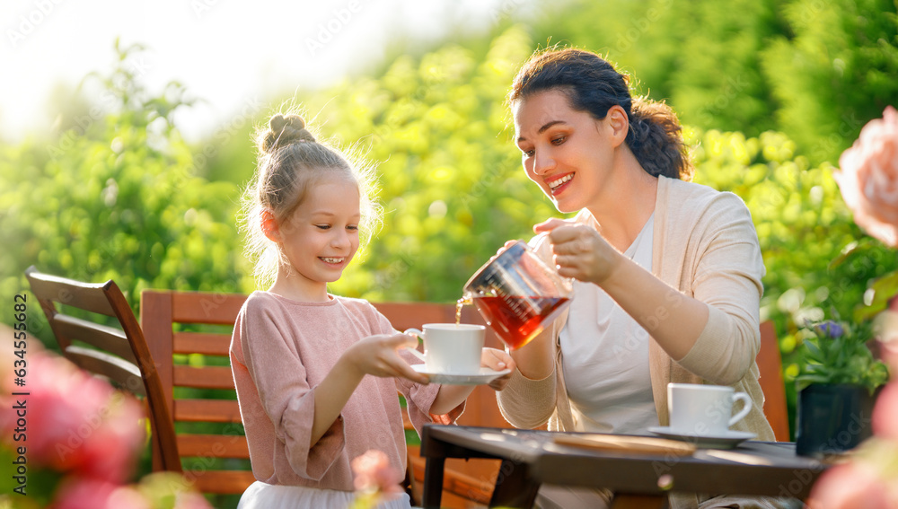 family drinking tea in the garden