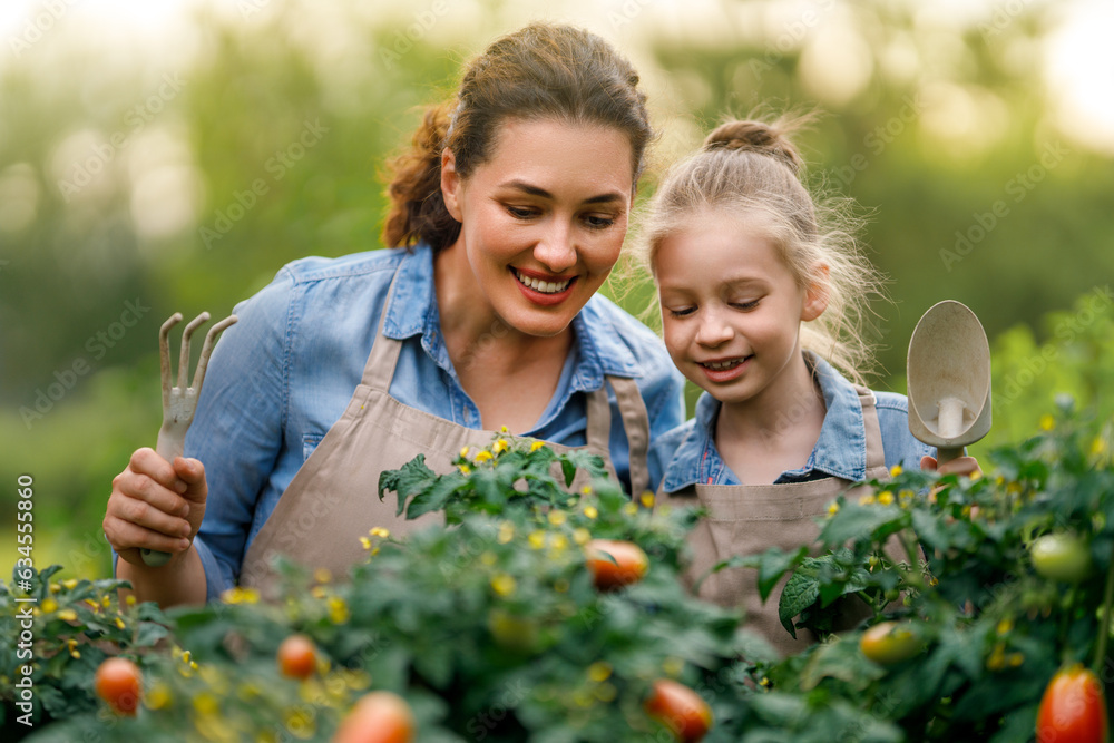 mother and daughter gardening in the backyard