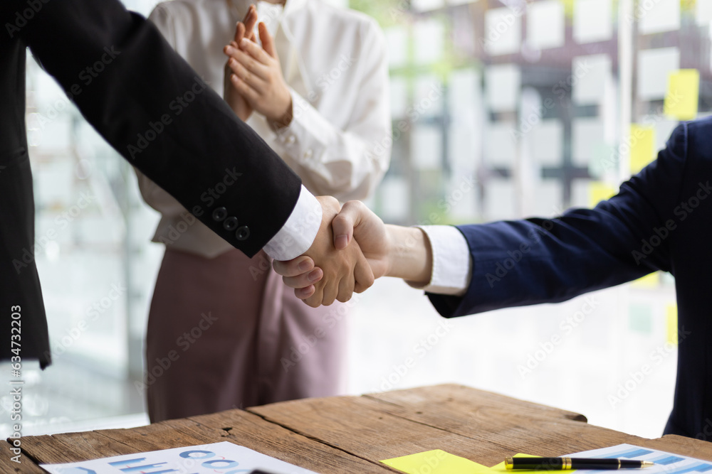 Business meeting, businesswomen shaking hands in business partnership meeting.