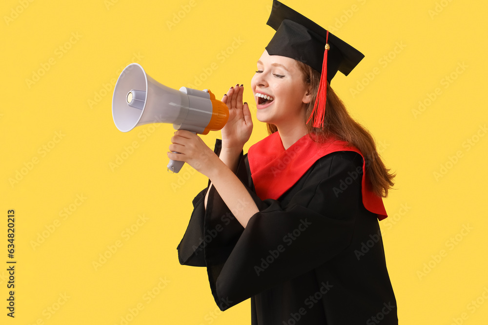 Female graduate student shouting into megaphone on yellow background